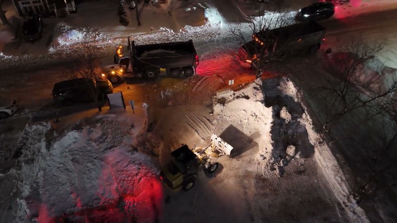 Snow removal filling trucks drone view 