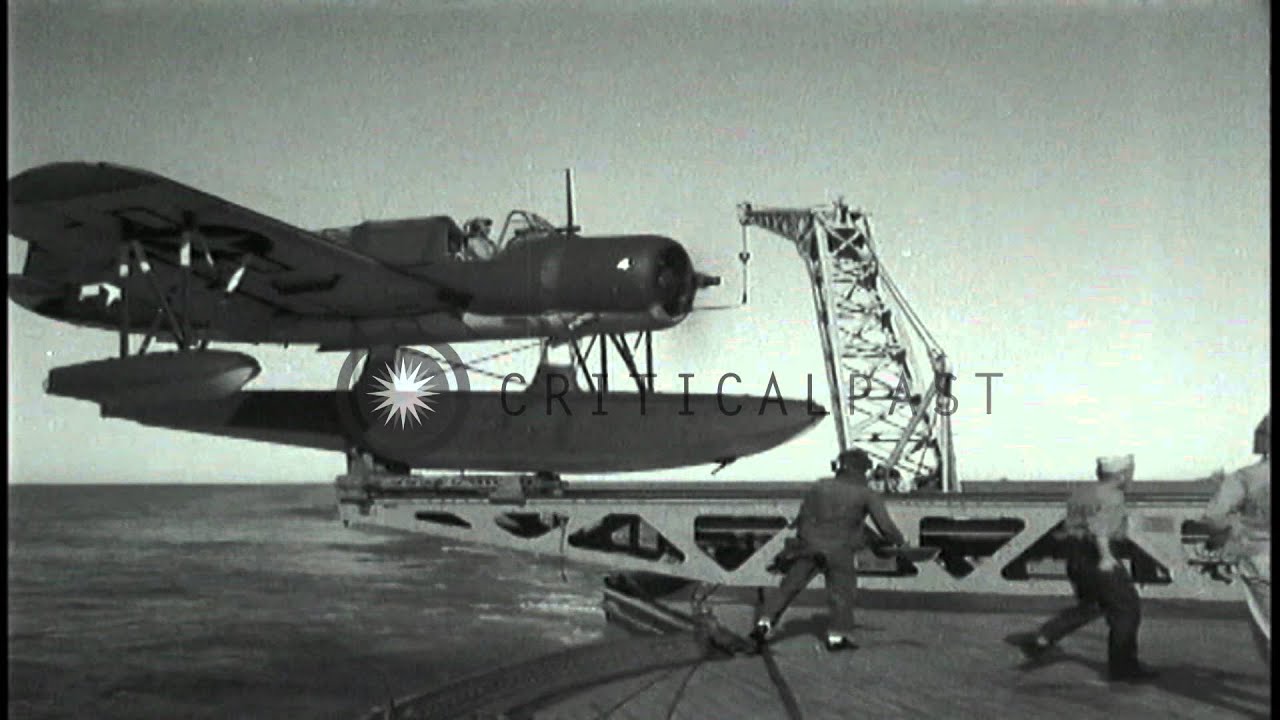 American float plane OS2U catapulted from battleship and bombardment at San Ferna...HD Stock Footage
