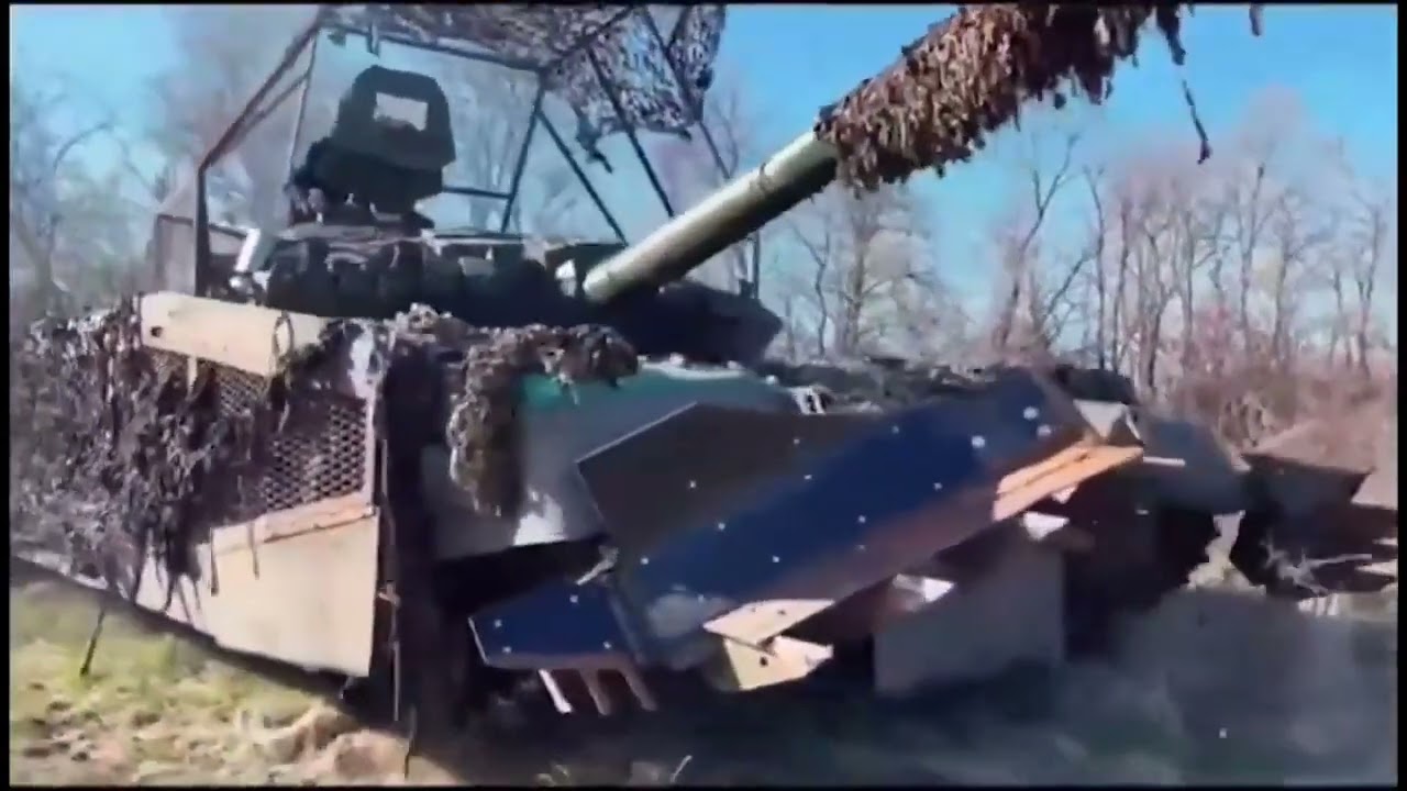 Ukrainian T-72M1 of 1st Separate TankBrigade with cope cage, extra side armor, mine plow.