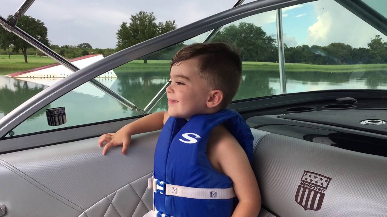 The Boy watching his Mom ride the wakeboard