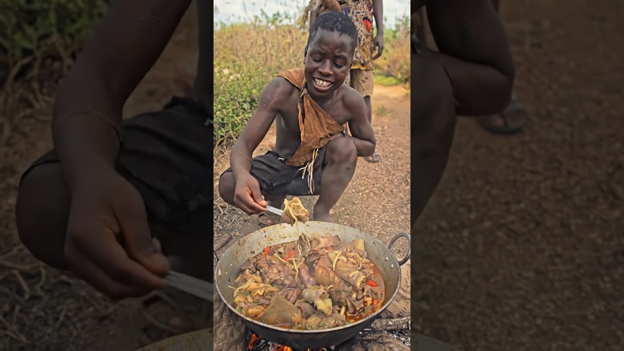 Hadzabe eating warm food during a quiet forest moment. 