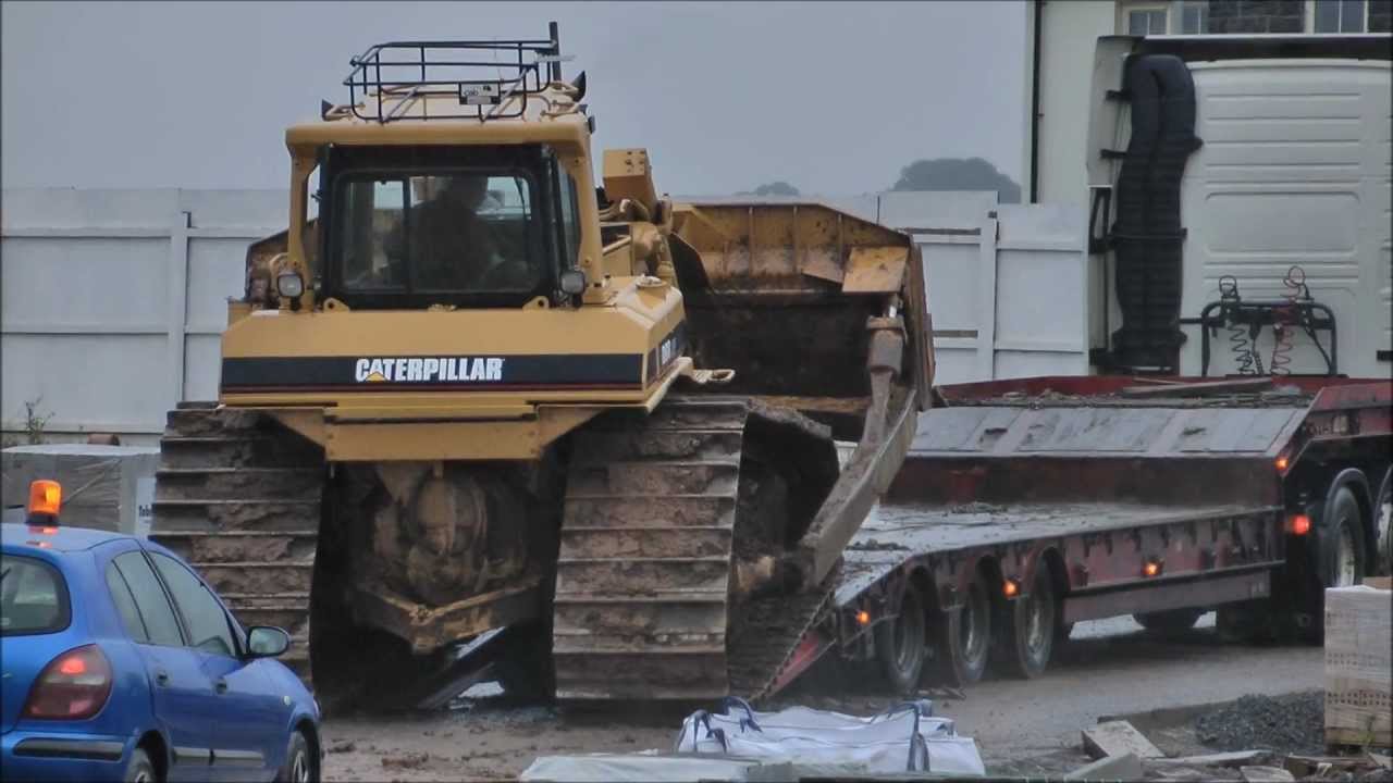 Bulldozer slips off truck