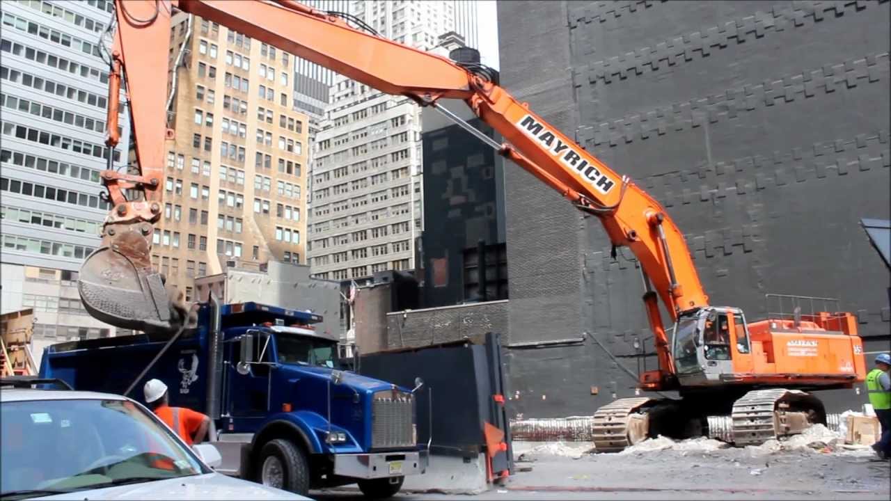 Hitachi ZX800 Triple Boom Excavator Loading Kenworth T800 Dump Truck