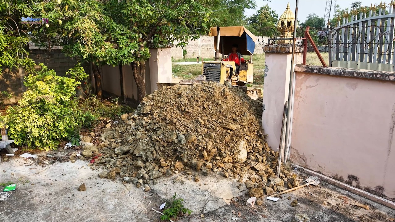 Nicely Processing! Good Job Of Bulldozer Push Stone Filling Up Low Land With Trucks Dumping