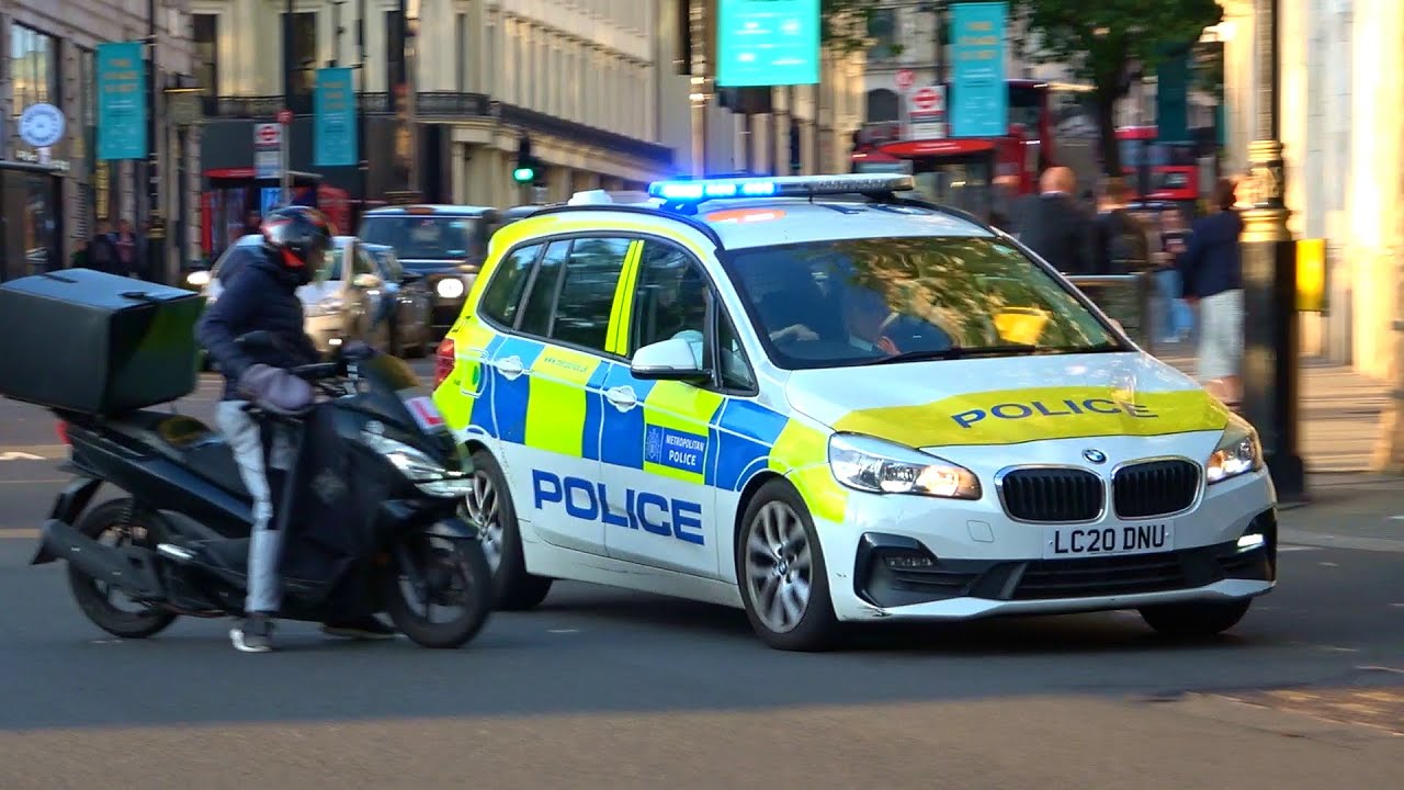 Near miss! Moped rider almost crashes into police car responding in London