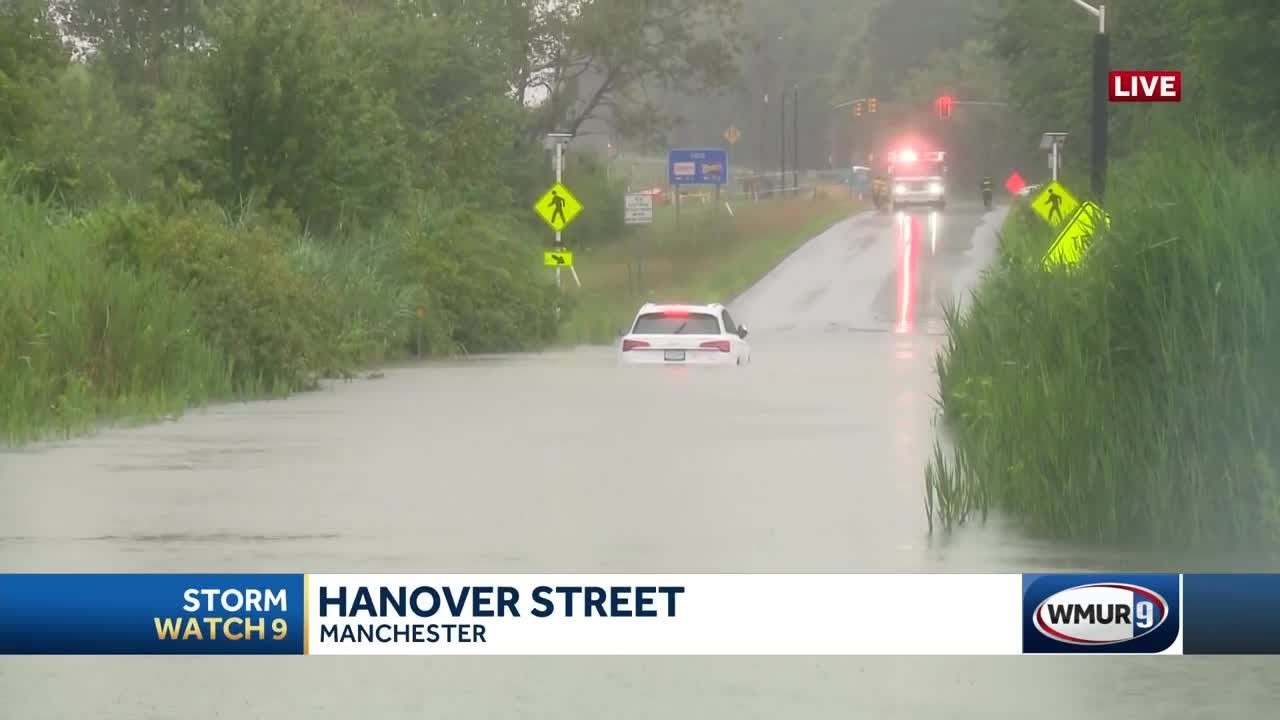 Driver rescued after car gets stuck on flooded road in Manchester