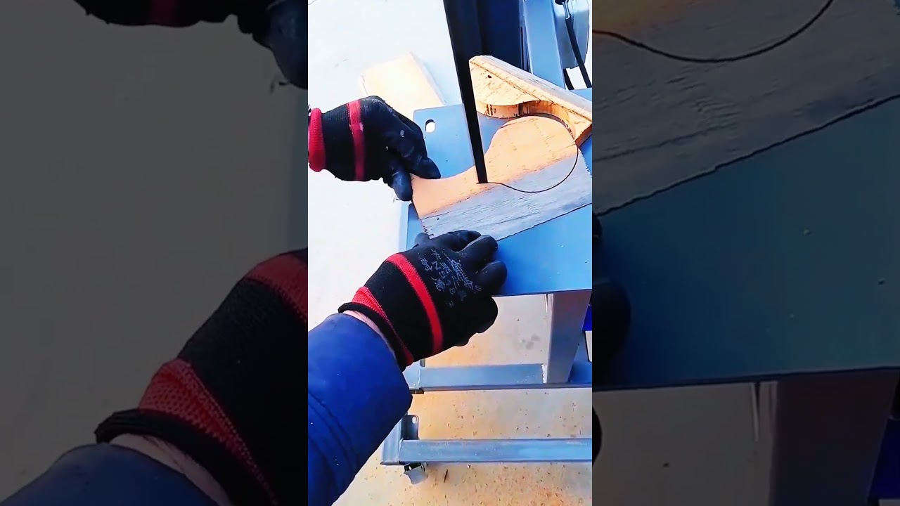 Bandsaw slices wood, curved design takes steady shape