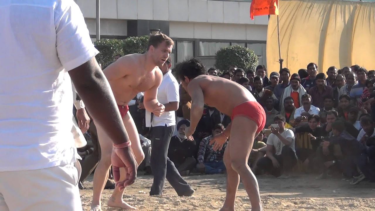 Timmothy Folly | wrestler from USA | wins a local traditional mud wrestling competition.