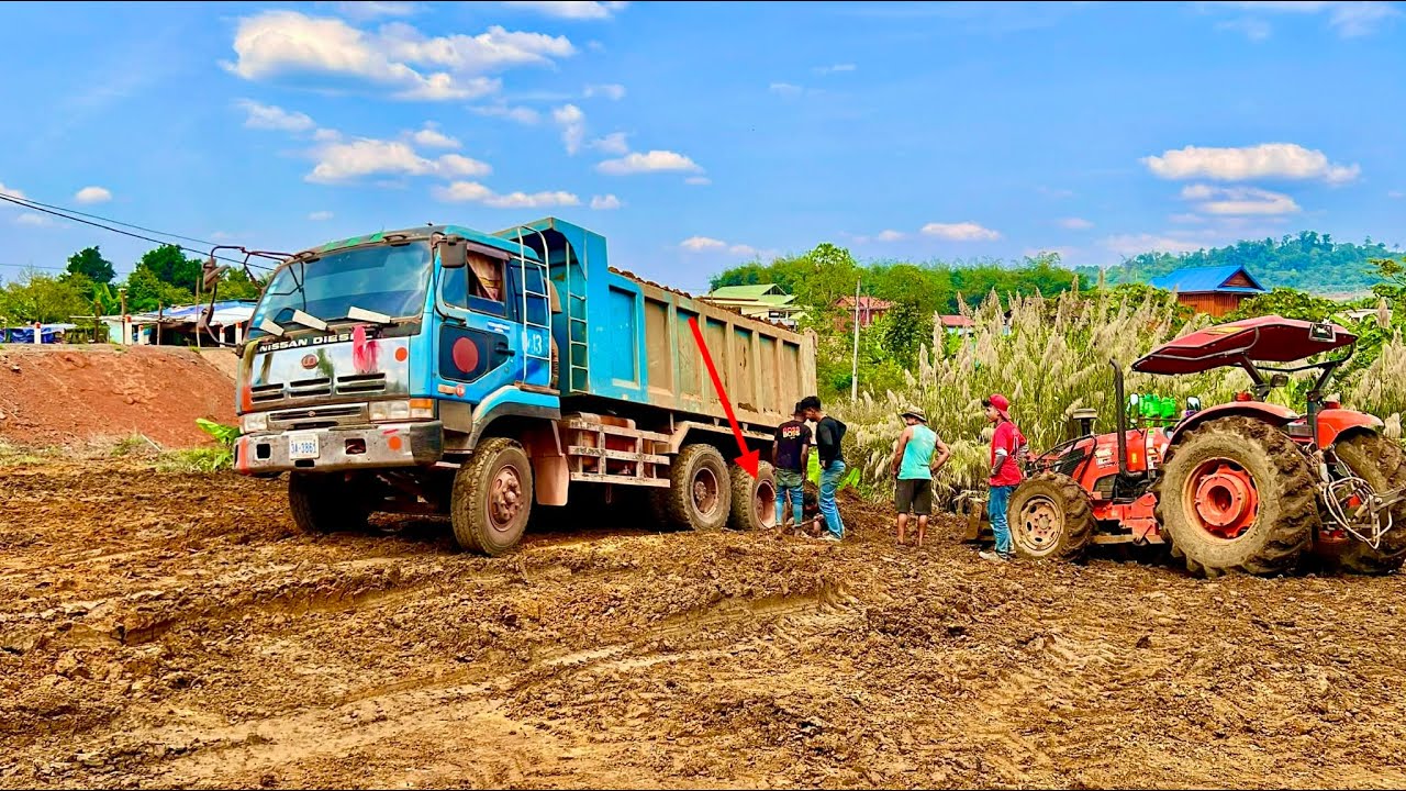 Tractor tries to pull stuck dump truck but fails