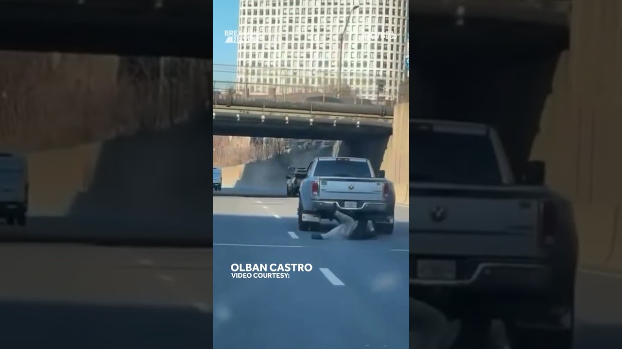 Watch: Man clings to back of pickup truck on Mass Pike