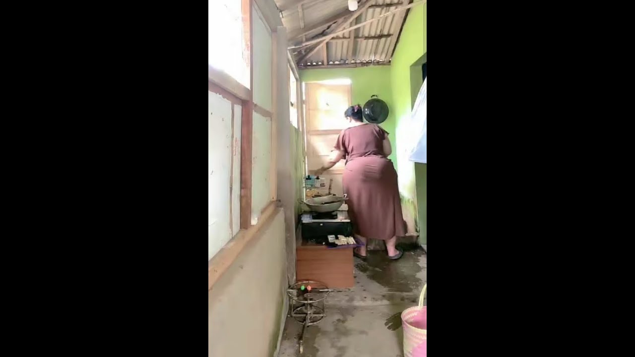 cooking lunch in the kitchen before washing the dishes and washing the children clothes