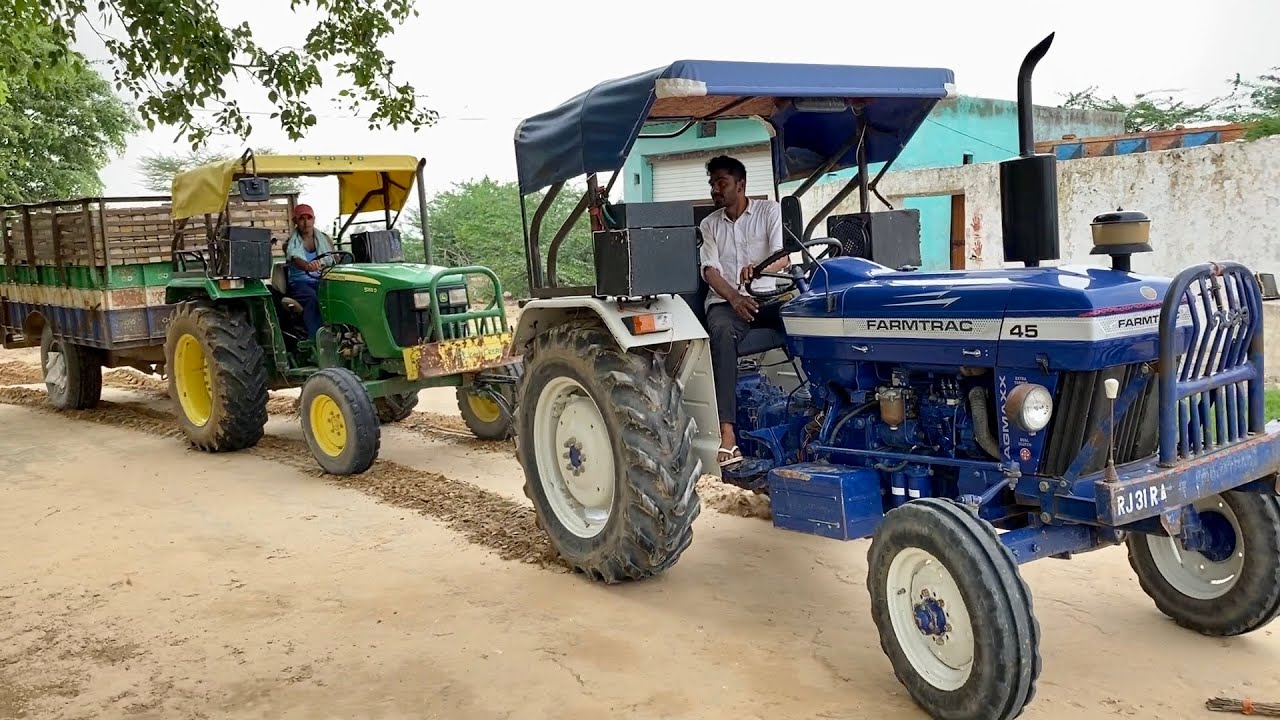 John Deere 5050 D stuck in trolley loaded with bricks Farmtrac 45 rescues stuck tractor
