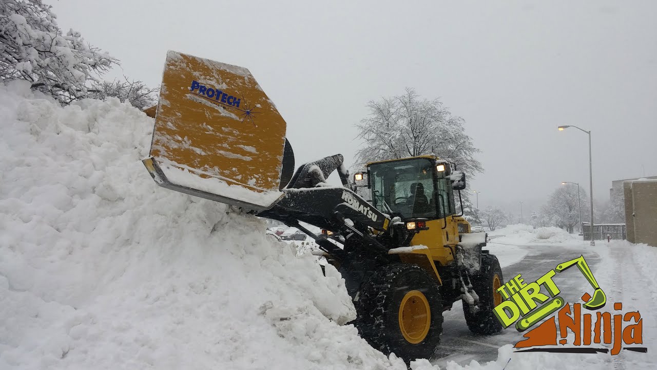 Wheel Loader Plowing Parking Lot