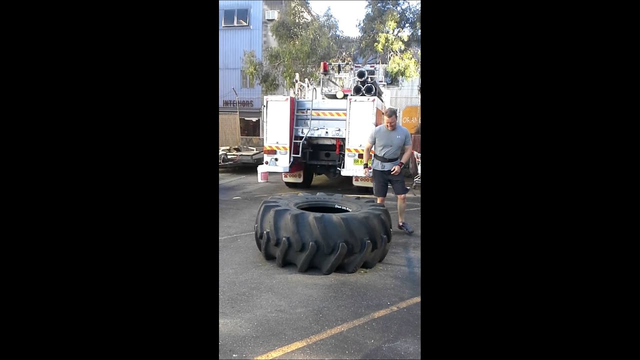 Ian Cairns lifting a huge tyre