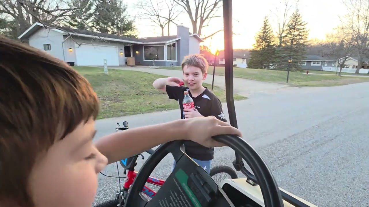 Siblings Drives Golf Cart 