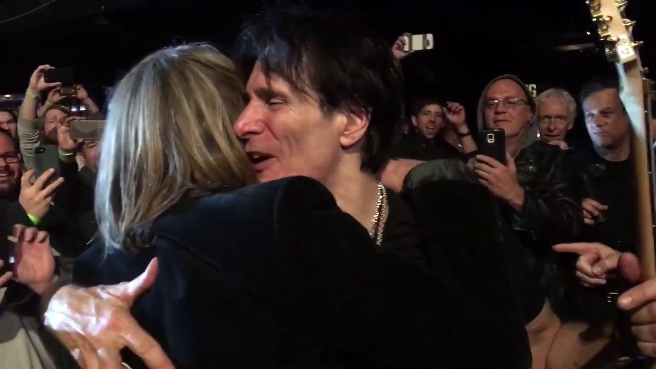Steve Vai hands off his guitar to Andy Timmons