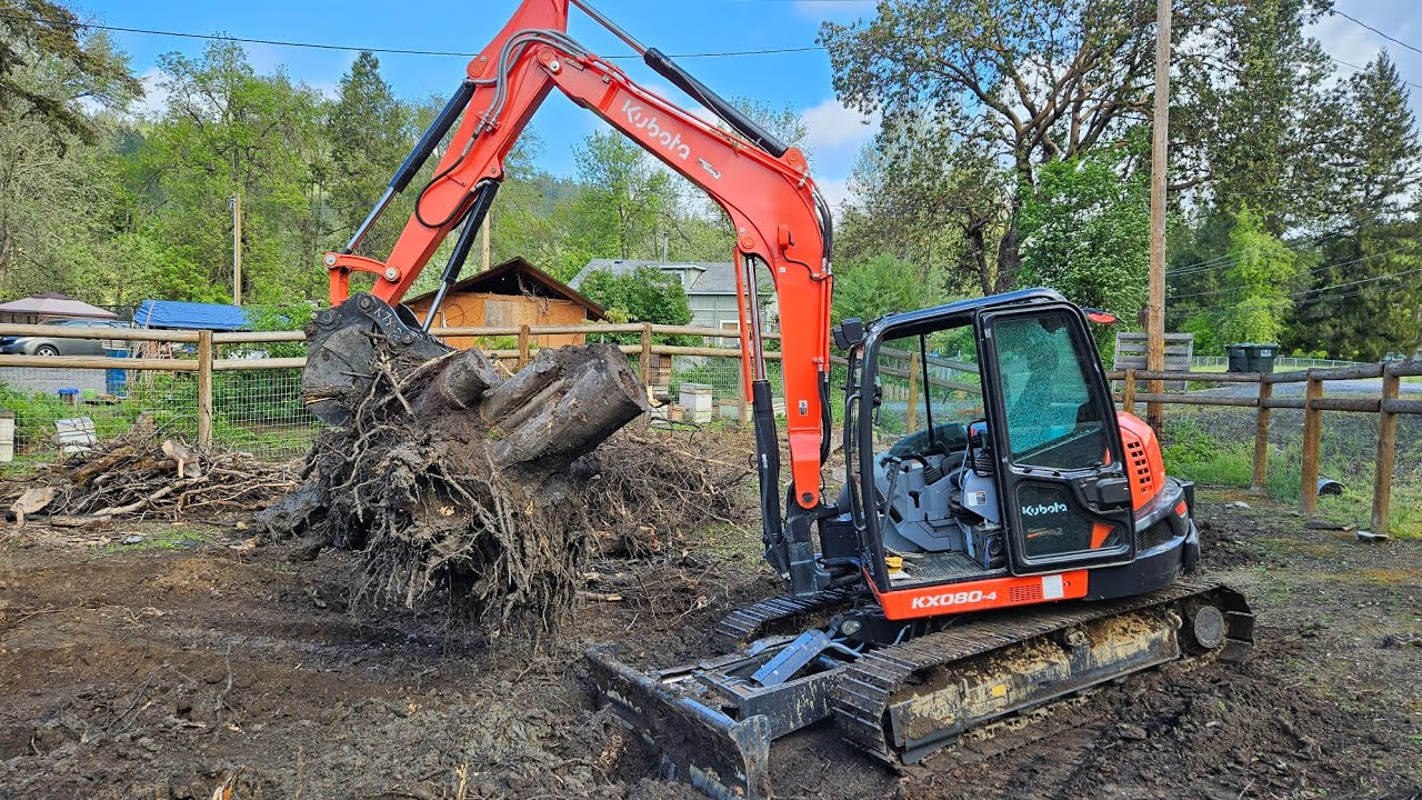 Broken window and tuff stumps with the Kubota KX 080 4