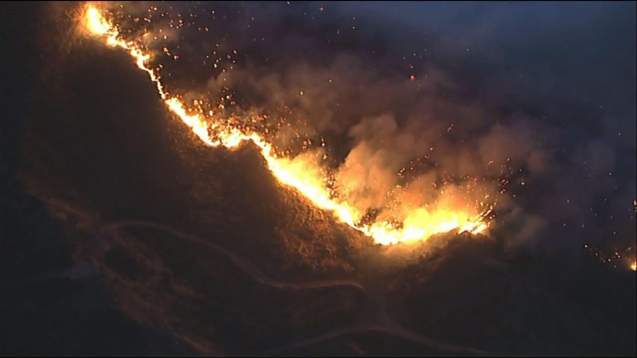 Helicopters fight fire along California hillsides