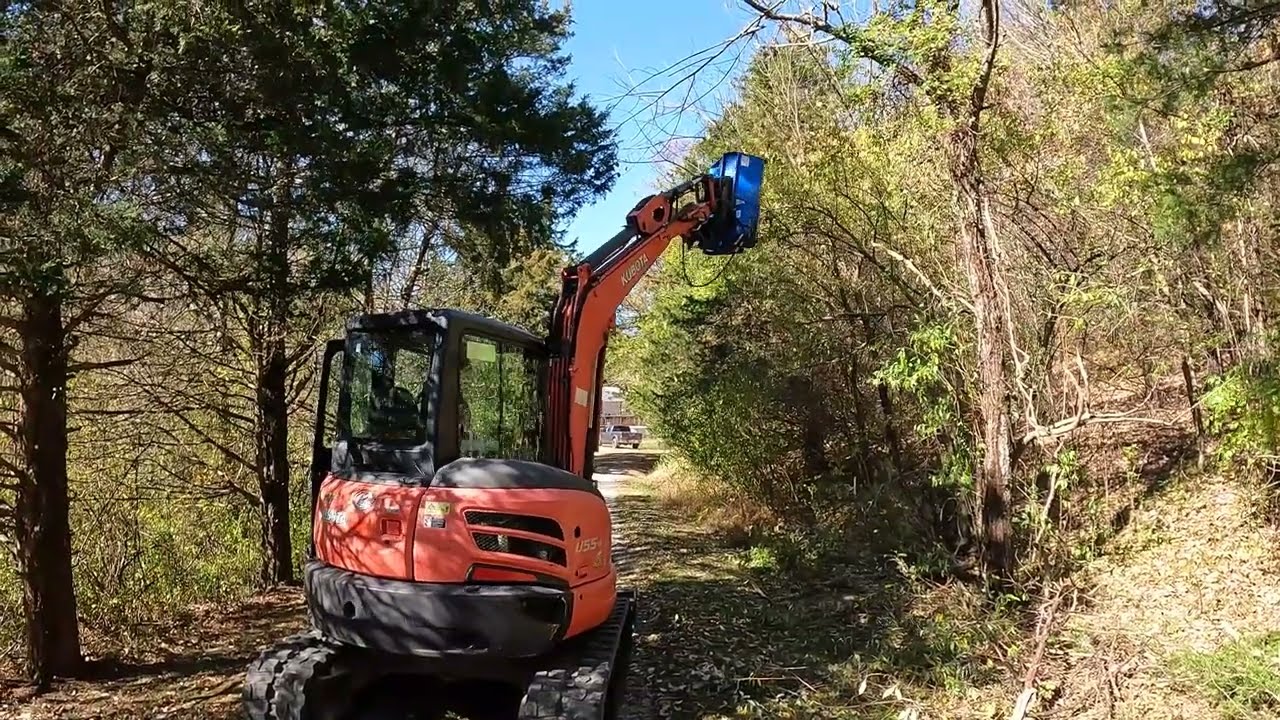 Brushcutting a driveway with the excavator flail mower