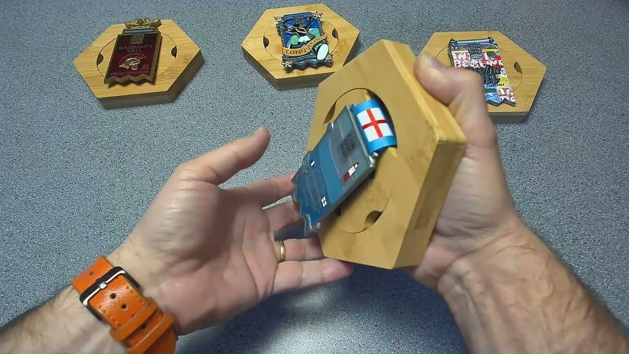 Conqueror Challenge medal's ribbon wrapped around display frame