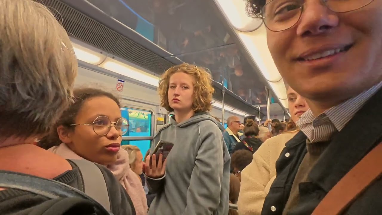 Paris Metro Eiffel tower to Glasiere station. People chatting on the subway during rush hour