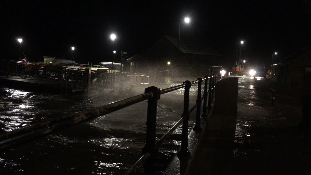 Fishing in Barmouth as the sea breaks into the street