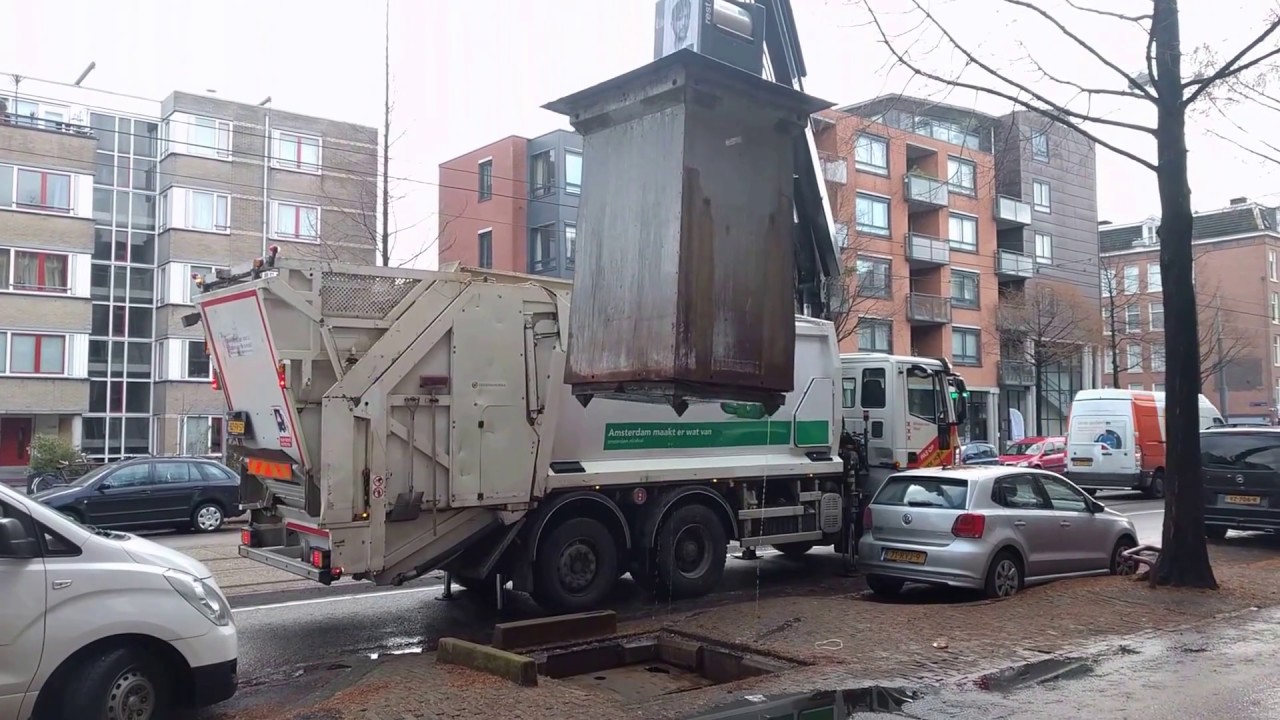 Garbage truck in Amsterdam using a crane
