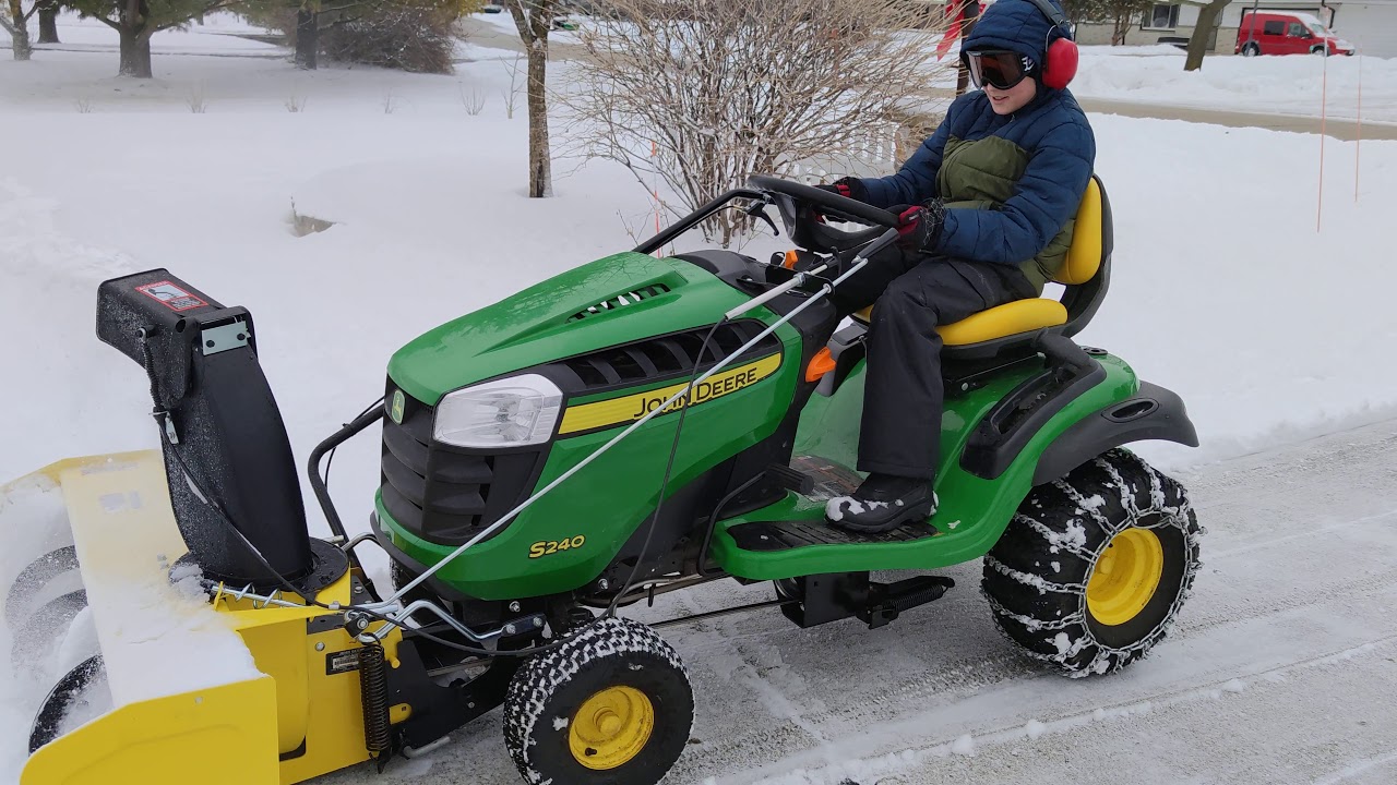 John Deere S240 with snow thrower/blower attachment.