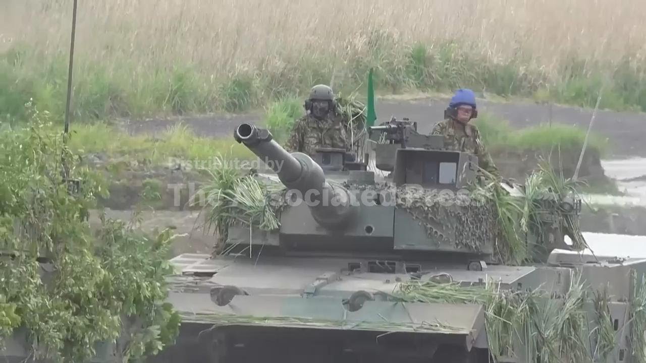 Japan's cabinet approves record defense budget that aims to deter China; AP explains