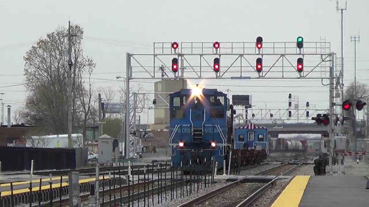 Metra 9 now graffitied leads a work train at Franklin Park