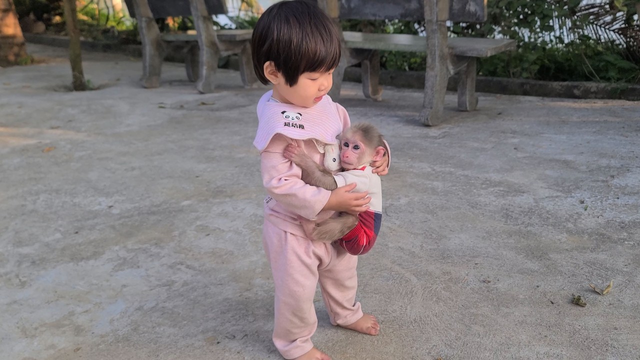 My older sister is hugging the adorable monkey Tini