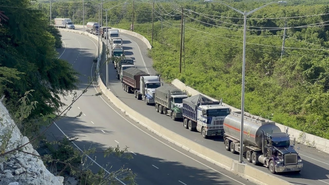 Trucks pass by on the St.thomas highway and climbing steep hills S10-E7