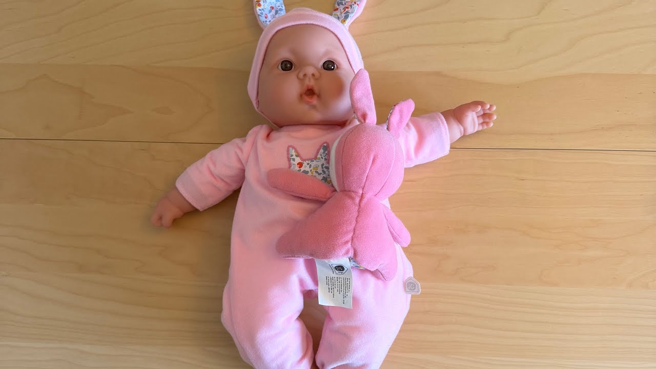 Pink baby doll, dresses, carrier seat and travel cot 