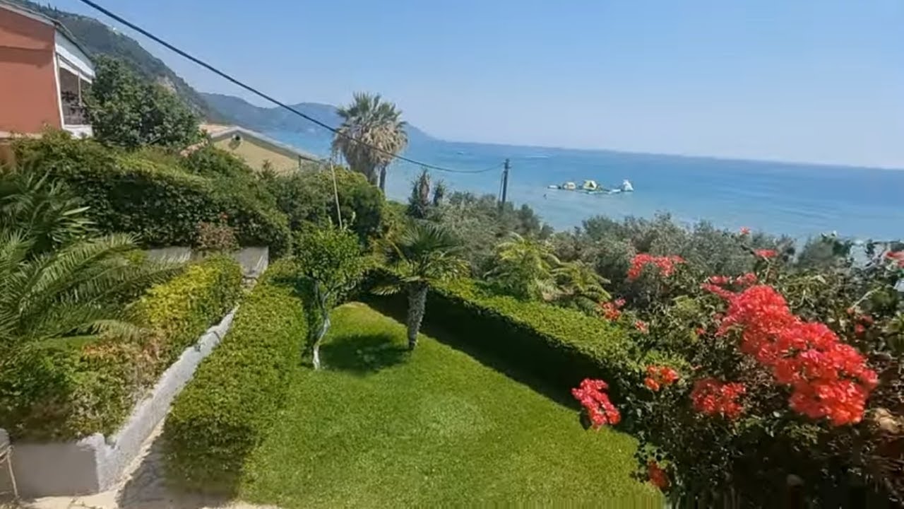 Glyfada Beach, Corfu Island, Greece. Glyfada Beach Corfu palm trees, aloe vera and huge cacti