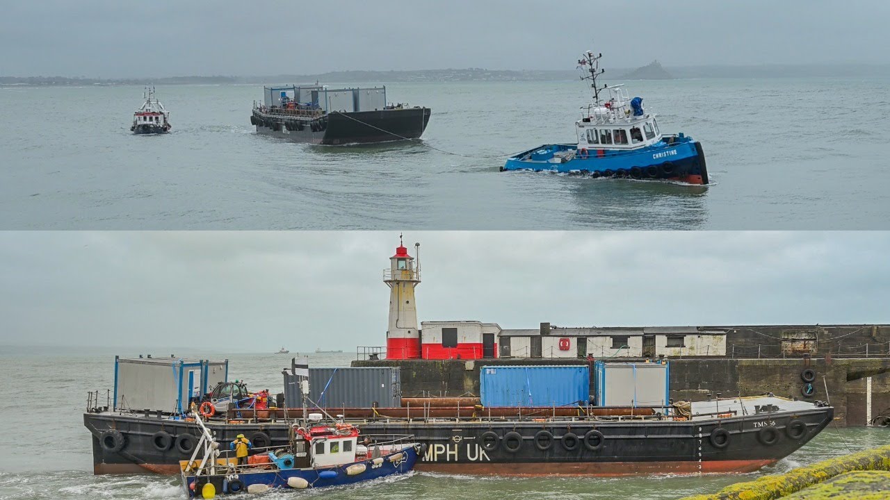 Tug Boat Pulls Barge Through The Narrow Gaps Of Newlyn Harbour, Cornwall In challenging Conditions