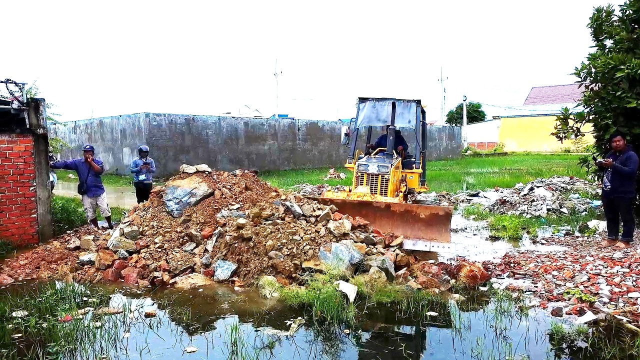Awesome Bulldozer Start to Pushing Rock to the very deep flooding by rain and work with bulldozer an