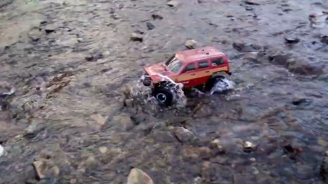 Lifted RedCat RC Woody Truck Driving In a Snow Melting Creek