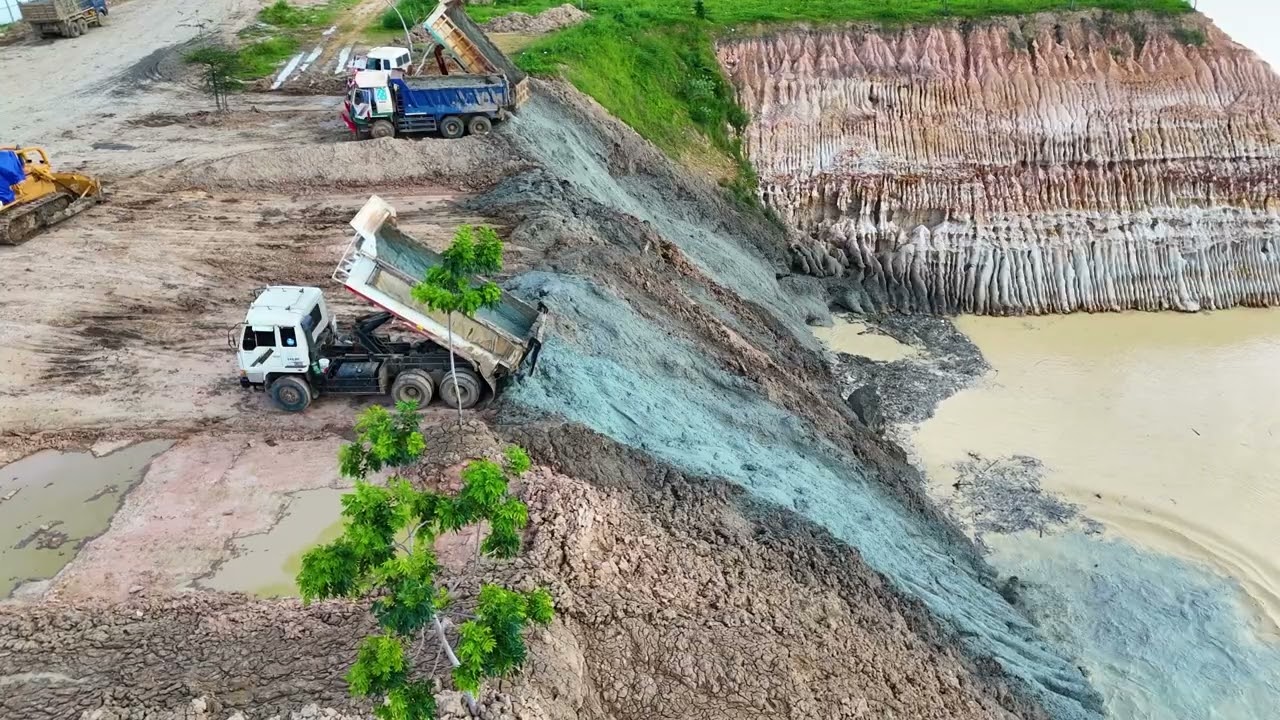 The act of dumping soil and garbage into a deep pit with a team of machinery