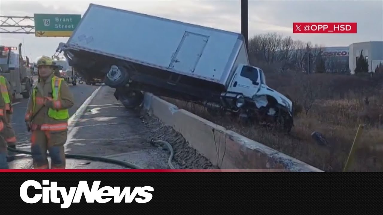 Truck veers off QEW, crashing over guardrail