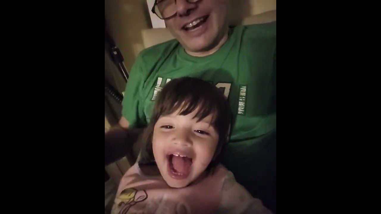 Kylie making funny faces on Daddy's Lap.