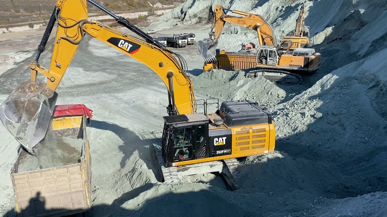 Caterpillar 352F - Caterpillar 385C And Liebherr 974 Excavators Loading Trucks