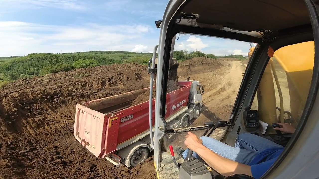 Excavator New Holland E305 loads trucks #22