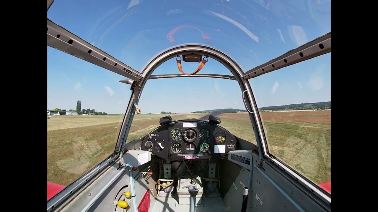 Zlín Z-226MS landing on grassy runway