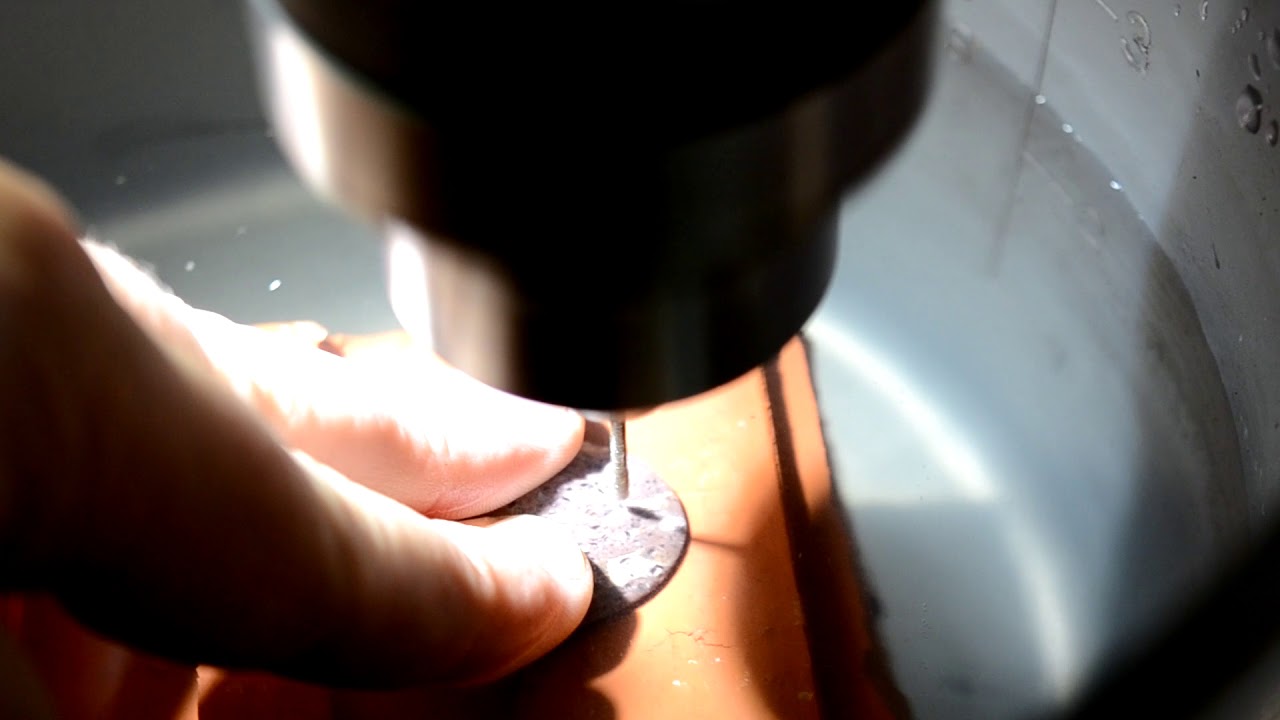 Drilling a hole in a rock for jewelry
