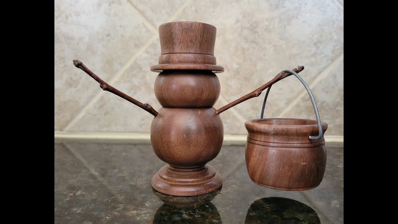 Walnut snowman and kettle turned on the wood lathe.