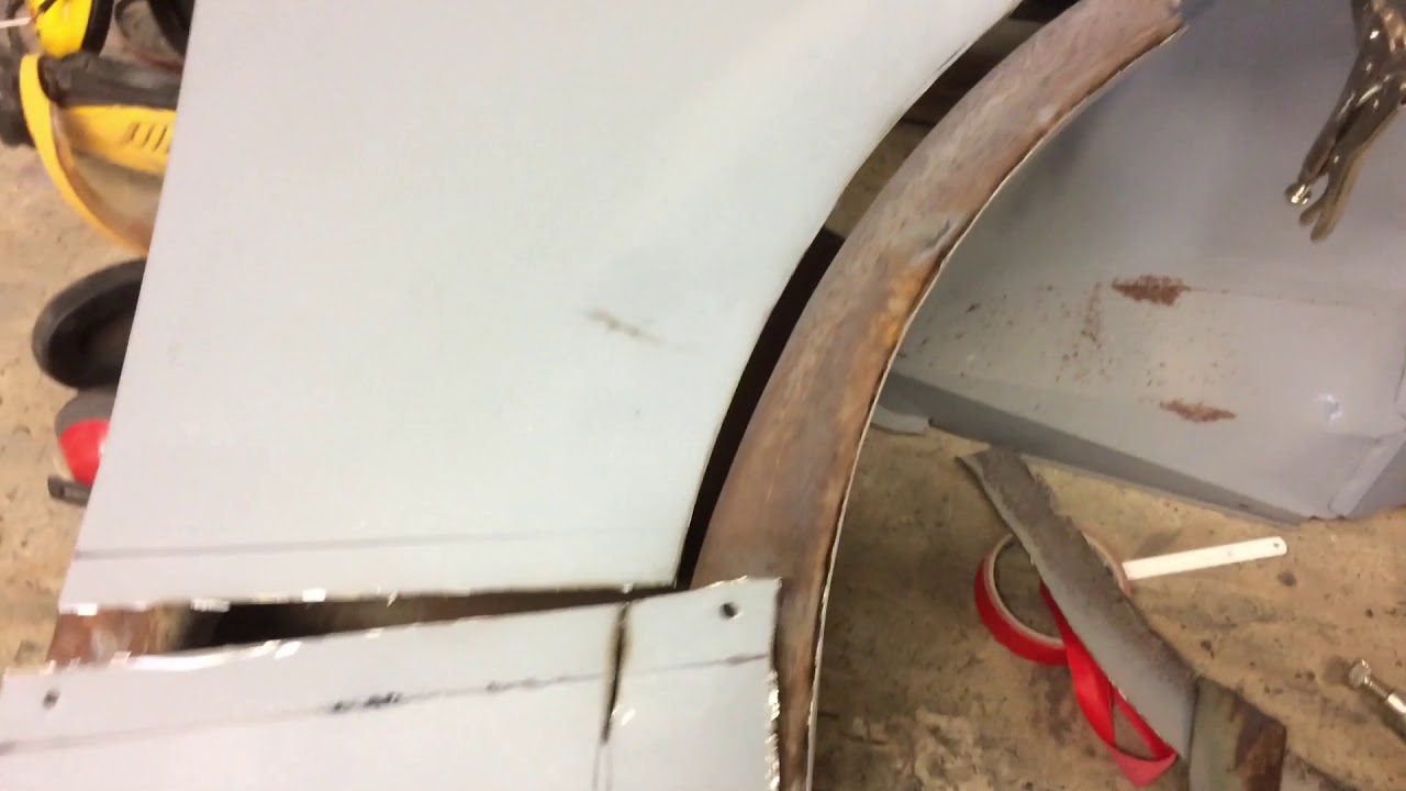 Citroen DS wing (other side) tacking in repair sections on rusted out wing ready for welding.