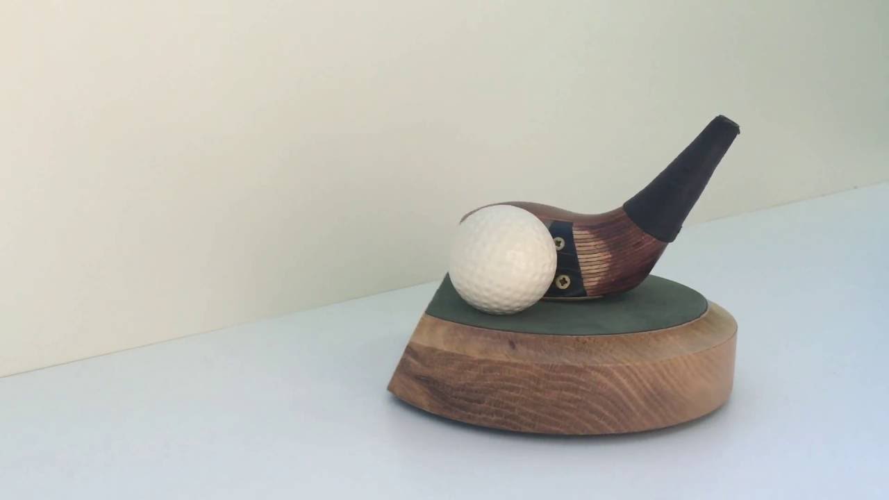 A vintage wood on a 6 inch cut away medium colour solid hardwood base with an antiqued golf ball