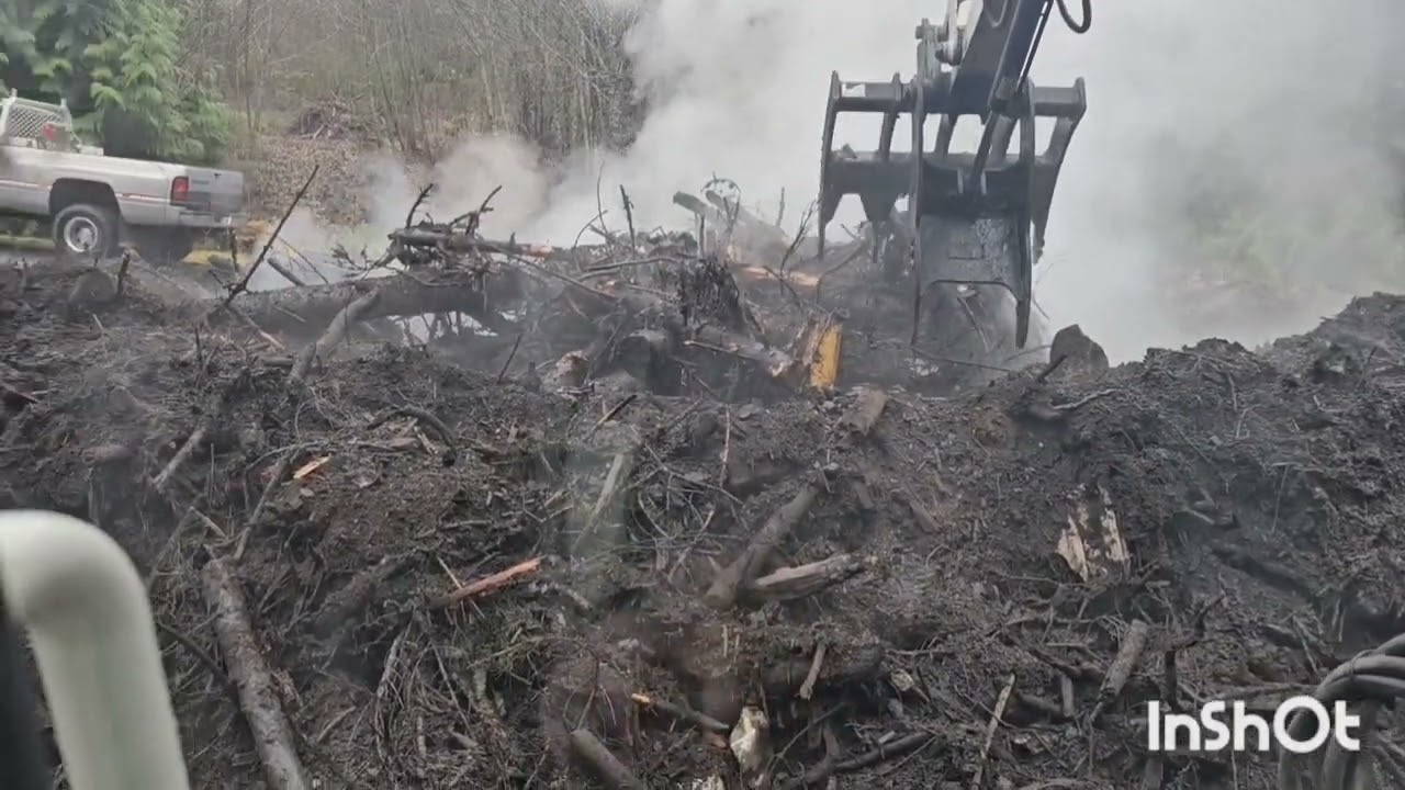 Cleaning up a burn pile with the Takeuchi TB260 mini excavator.