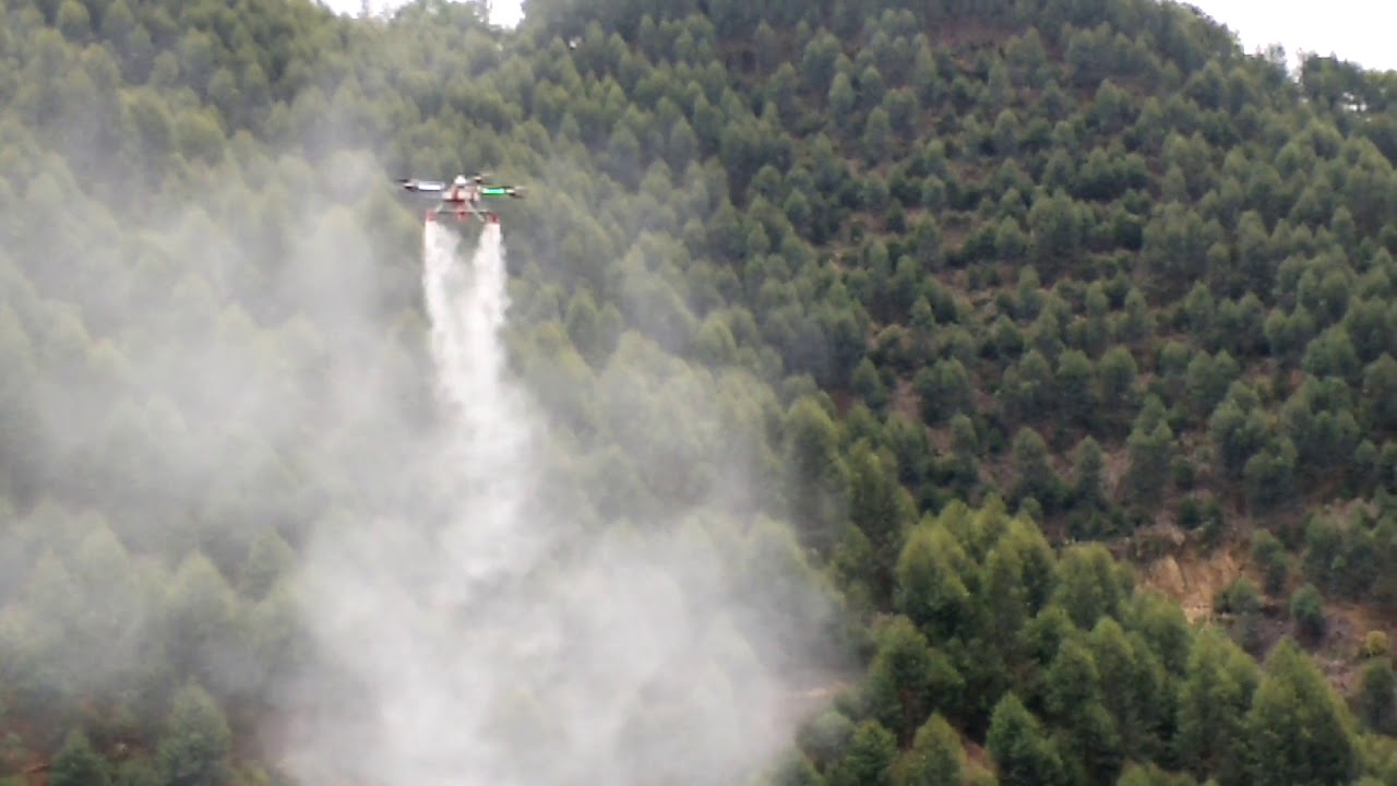 Agri drone spraying powder on forest