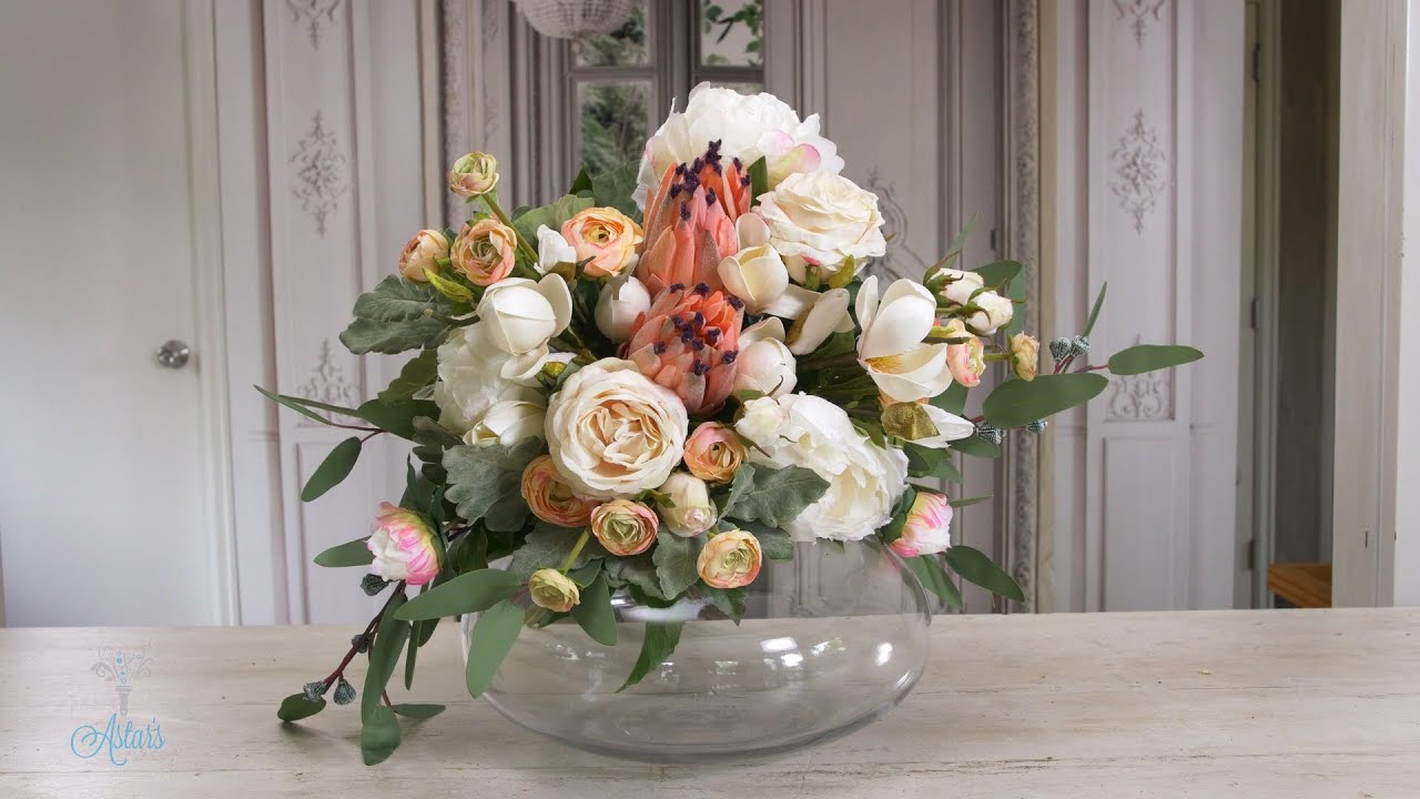 A Bridal Bouquet: Pink mink protea, white peonies, roses, ranunculus & magnolia | Wedding Flowers